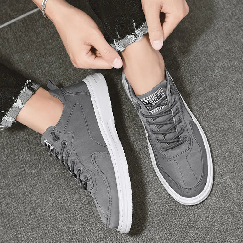 Men's canvas sneakers with letter print, elastic lace-up, breathable mesh lining, platform rubber sole, available in green black grey.