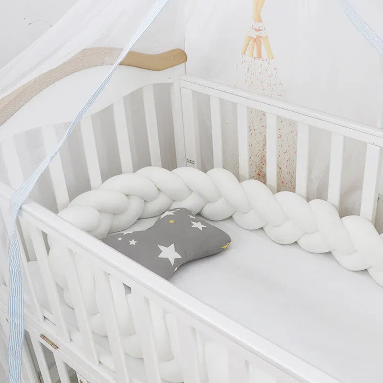 Baby crib bumper braid knot pillow cushion in spandex velvet fabric, shown in a multi-colour option.