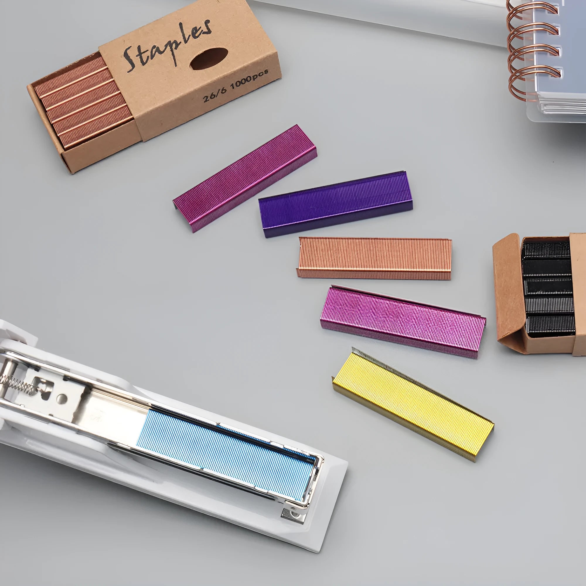 Box of 1000 metal staples in rose gold, black, purple, and rose red colours for office staplers