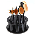 Round black plastic makeup brush holder with 10 holes for storing brushes upright on a vanity or bathroom counter