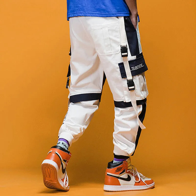 Men's loose fit hip hop beam pants in khaki cotton-rich fabric, mid waist, tether closure, small feet hem, available in black and white.