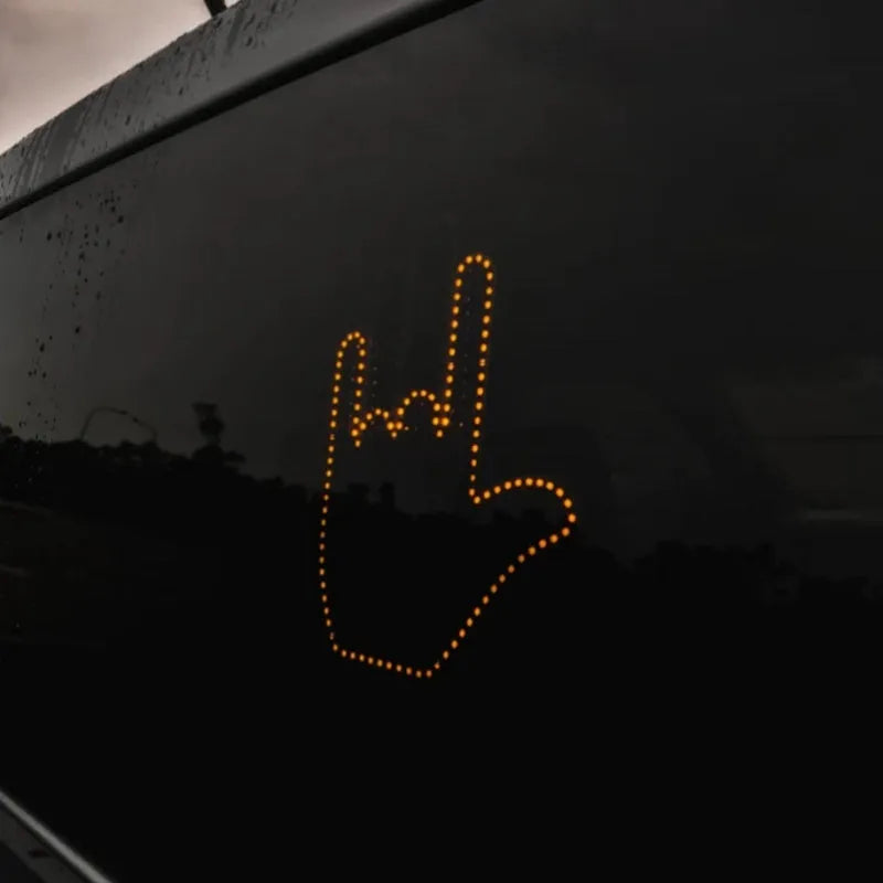 Black plastic LED car gesture light showing middle finger gesture with remote control