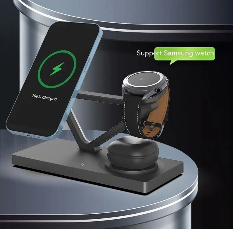 White five-in-one wireless charging station with night lamp, magnetic phone bracket, and watch charging pad on a bedside table.