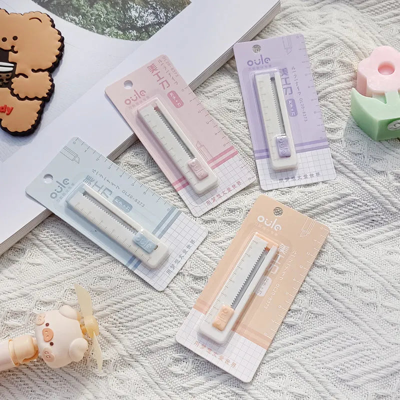 Small plastic art knife in blue colour measuring 7.2cm long for cutting paper and packages