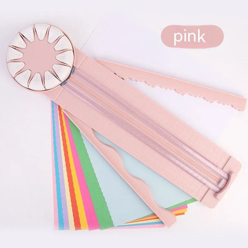 Pink plastic paper cutting machine with dotted alignment guides and 12 cutting patterns
