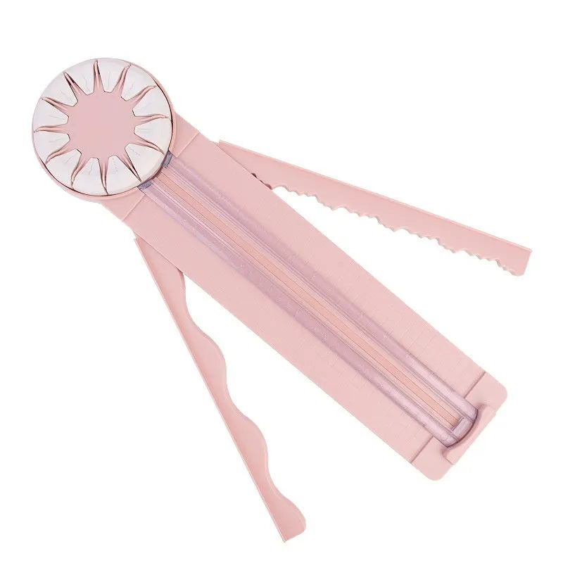 Pink plastic paper cutting machine with dotted alignment guides and 12 cutting patterns