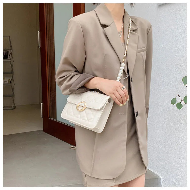 Diamond chain shoulder crossbody bag in soft PU with three-dimensional pocket design, shown in blue, black, beige and cream options