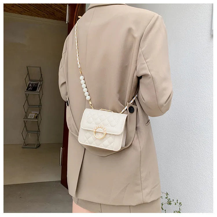 Diamond chain shoulder crossbody bag in soft PU with three-dimensional pocket design, shown in blue, black, beige and cream options