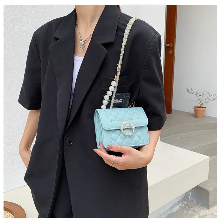Diamond chain shoulder crossbody bag in soft PU with three-dimensional pocket design, shown in blue, black, beige and cream options