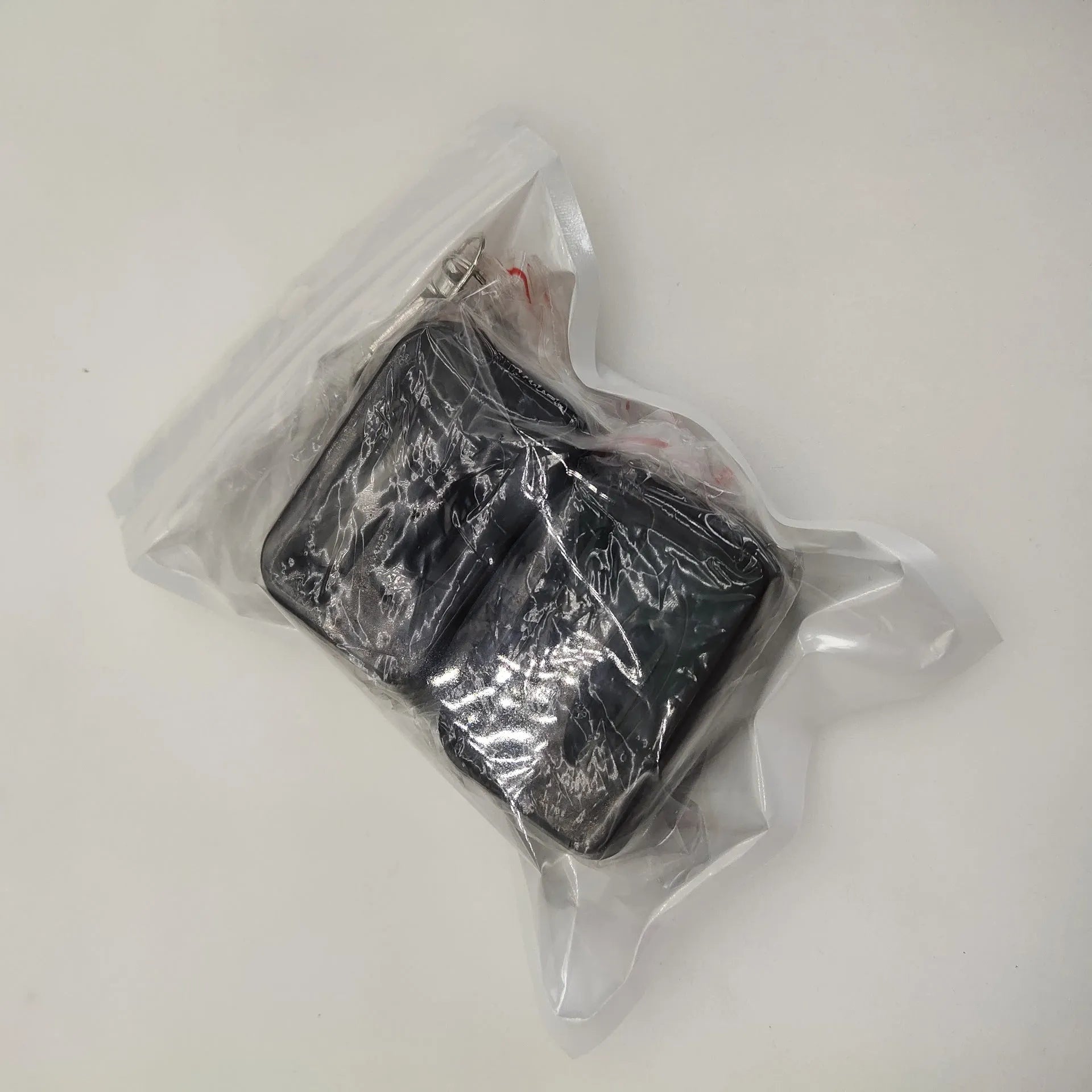 Black and red seat belt lock protective clamp made from ABS plastic