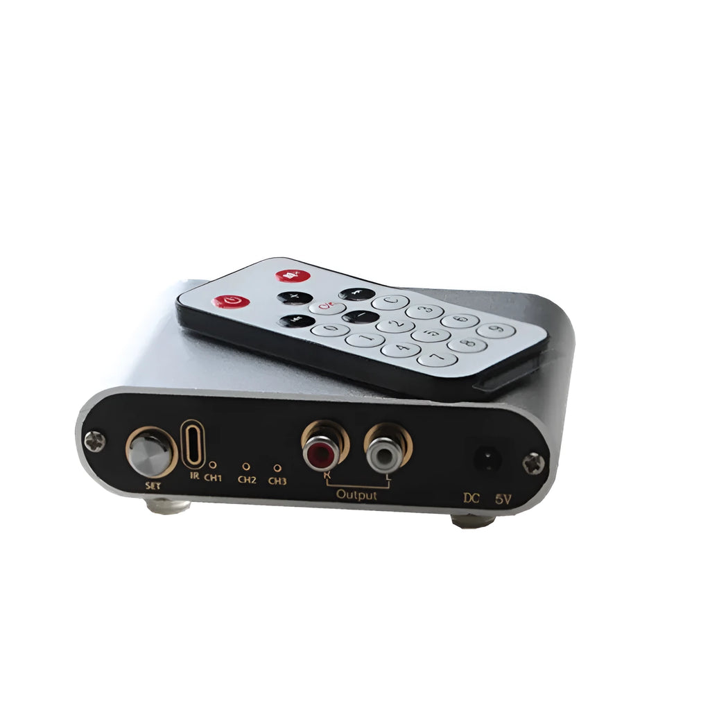 Silver aluminium alloy audio source selector switch unit with front-panel buttons and infrared remote.