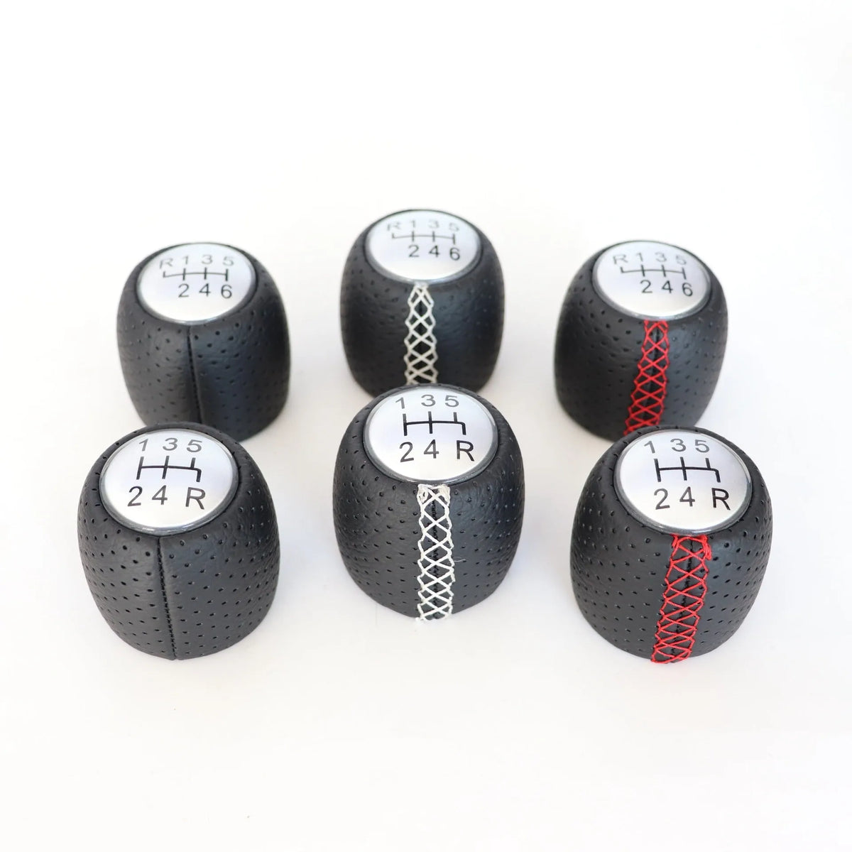 Sewn wrapped perforated leather gear handball for Toyota Alpha in matte and silver finishes.