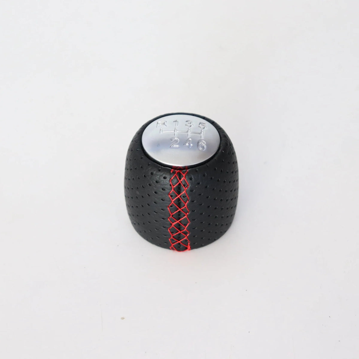 Sewn wrapped perforated leather gear handball for Toyota Alpha in matte and silver finishes.