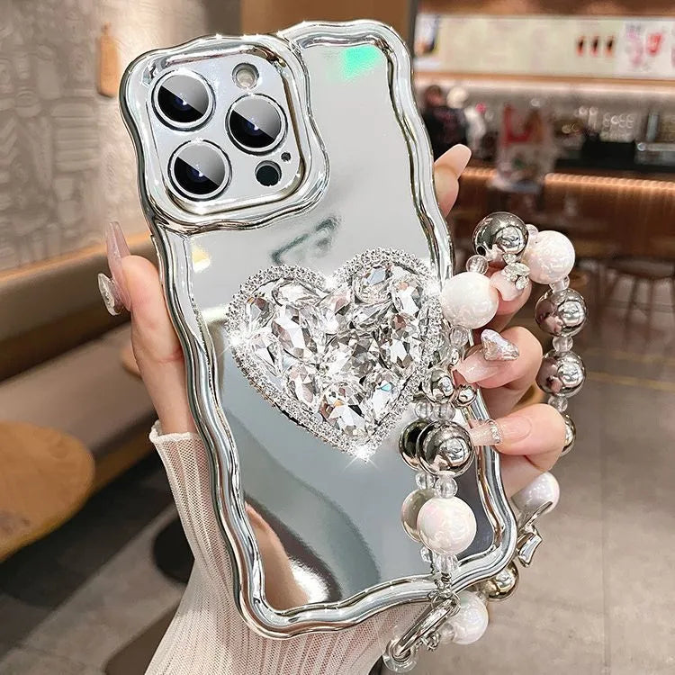 Silver grey silicone iPhone case with mirror finish, rhinestone bracket, and wrist strap lanyard