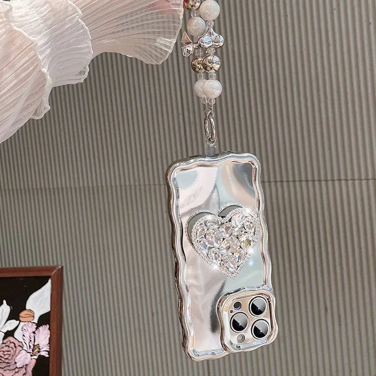 Silver grey silicone iPhone case with mirror finish, rhinestone bracket, and wrist strap lanyard