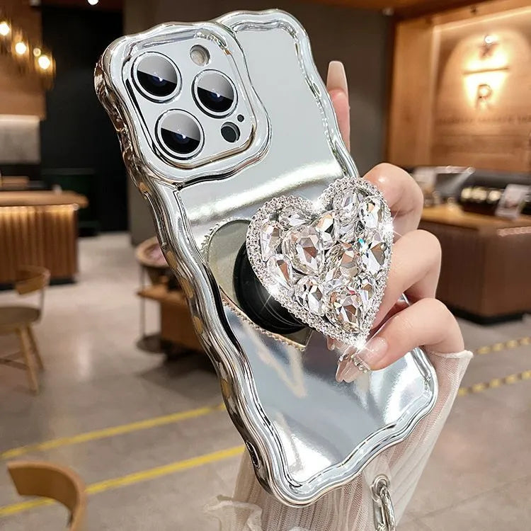 Silver grey silicone iPhone case with mirror finish, rhinestone bracket, and wrist strap lanyard