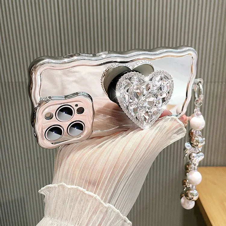 Silver grey silicone iPhone case with mirror finish, rhinestone bracket, and wrist strap lanyard