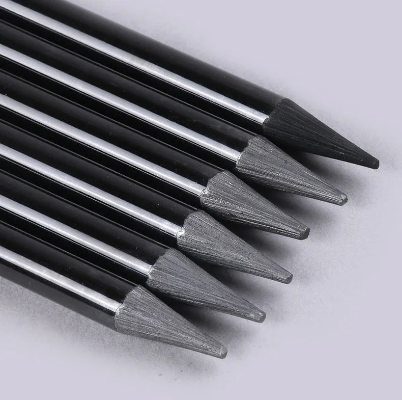 Set of six graphite and three carbonised drawing pencils with wooden shells on suction card packaging.