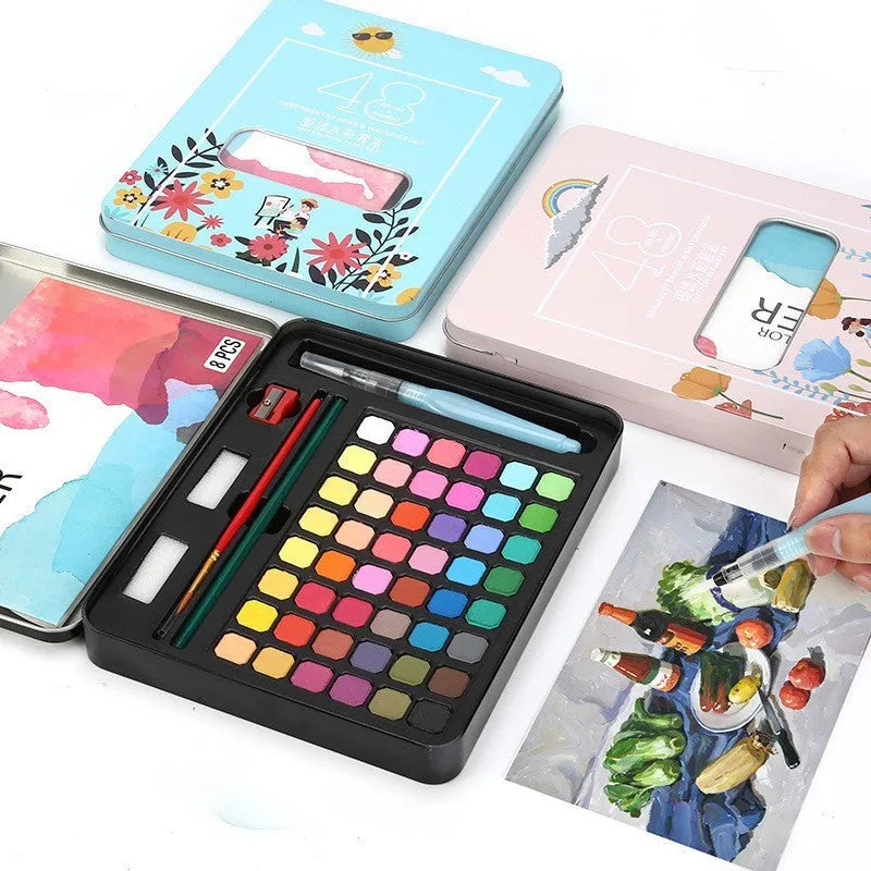 Box of 48 solid watercolour paint cakes showing colours including Black Knight, Girl Pink, and Sunshine Blue.