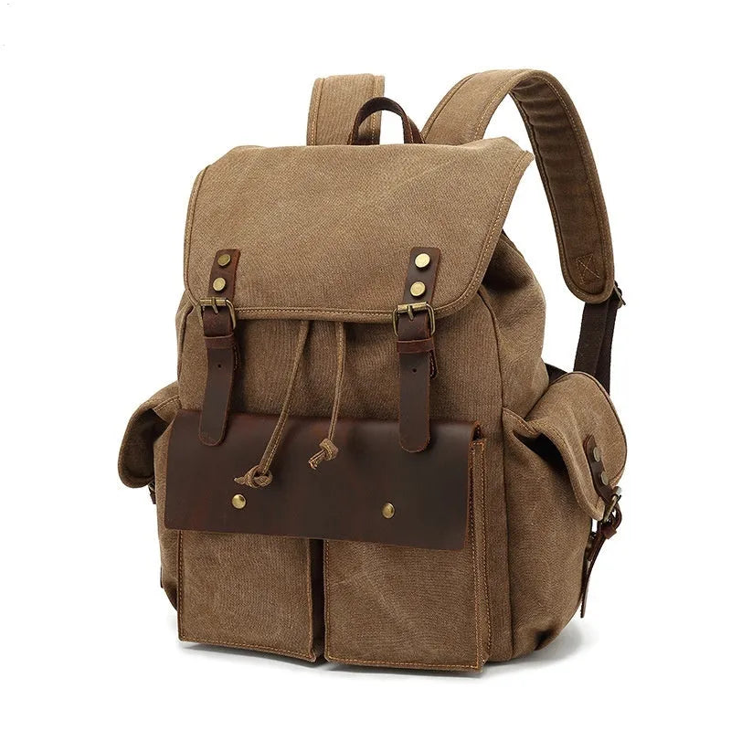 Retro military green canvas backpack with antique bronze hardware on a plain background.