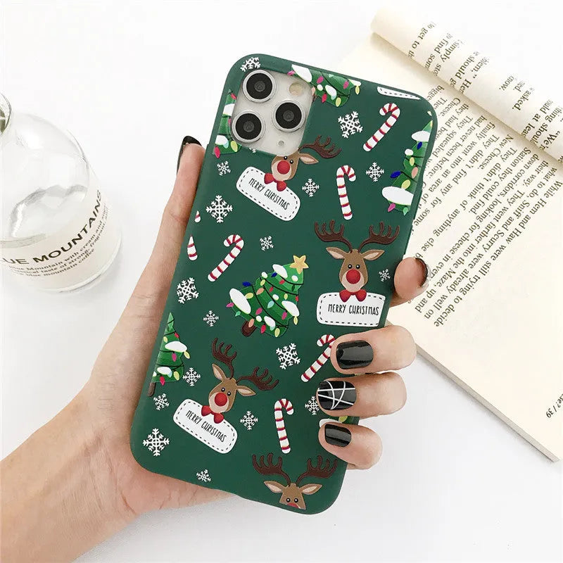 Green TPU iPhone case with a cartoon Christmas elk and tree design beside stripes.