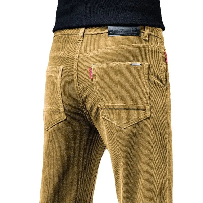 Men's straight slim-fit corduroy trousers in black, cotton fabric, side view on model