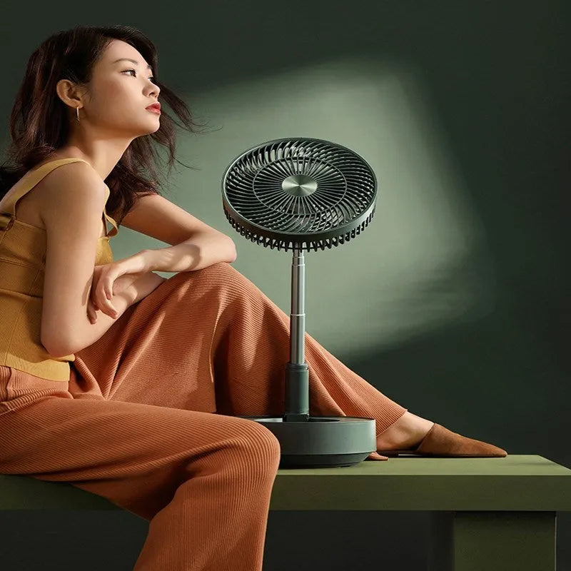 Green telescopic floor-standing electric fan with remote control in extended position