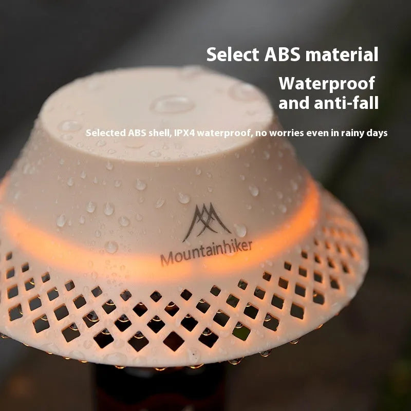 Beige wine bottle shaped camping lantern with USB-C port and control gear on top.