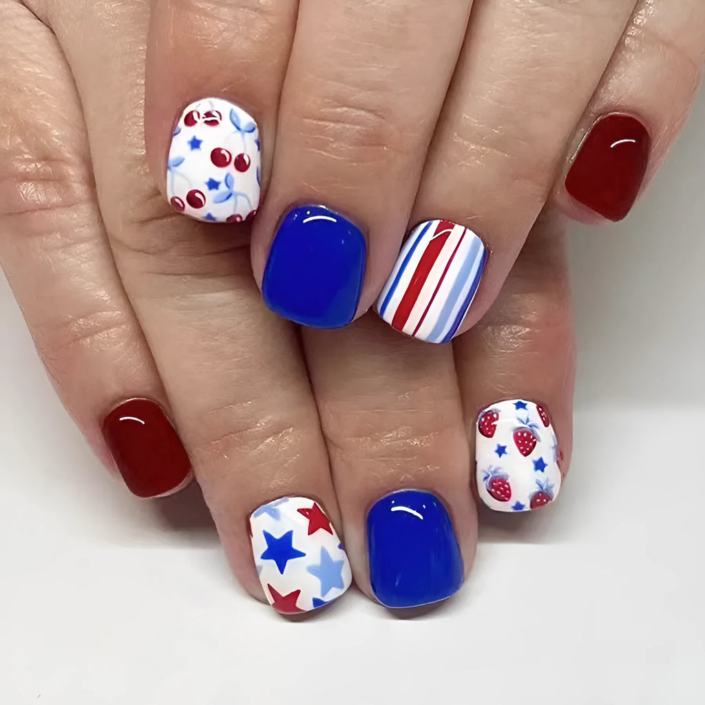 Short glossy false nails with strawberry cherry independence day pattern in red and blue colours