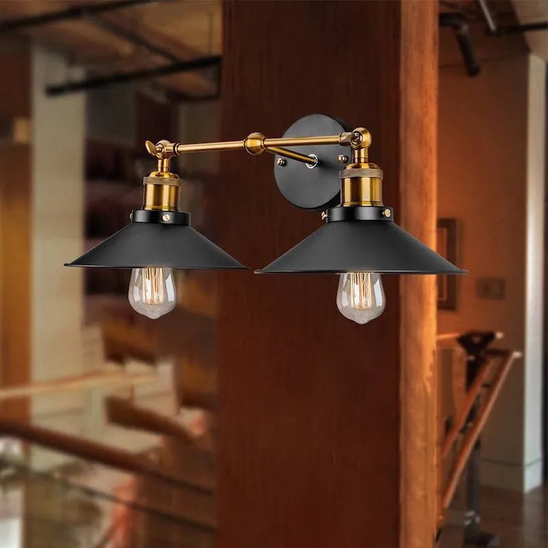 Black double head American retro industrial style iron wall lamp on a wall.
