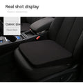 Black thick memory foam car seat cushion on a driver's seat