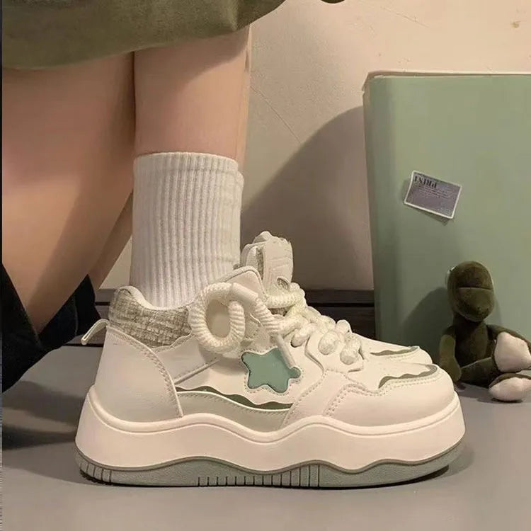 Women's green patent leather platform sneakers with round toe and white laces