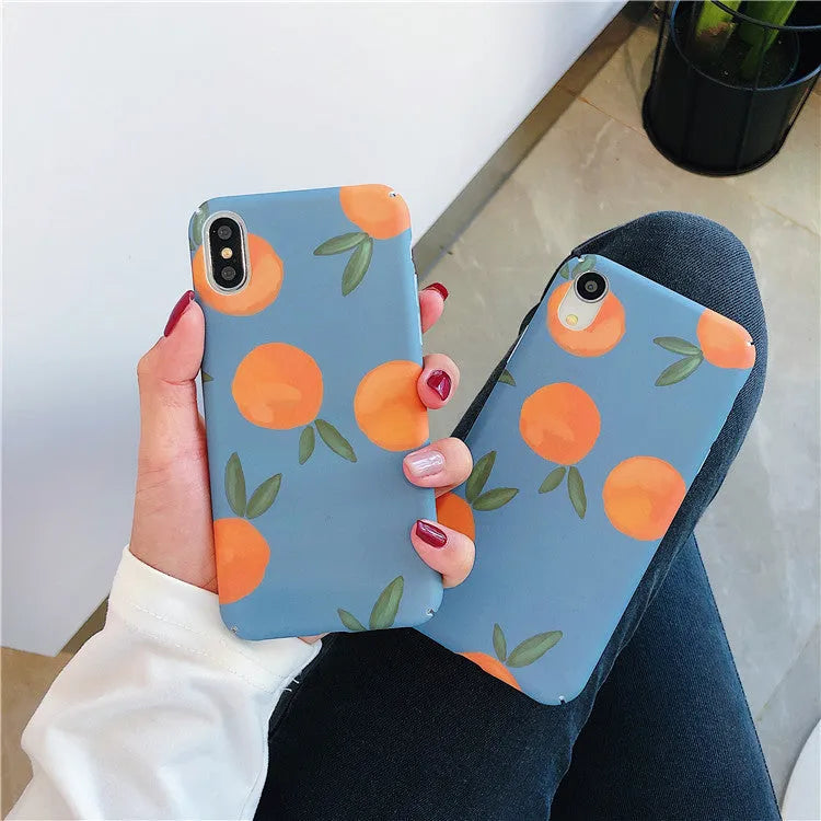 Retro orange and blue plastic back cover case for iPhone models on a table.