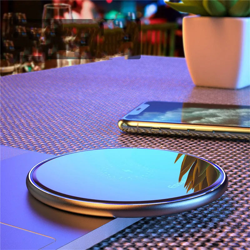 Black wireless charging pad with LED indicator light for phones and headphones
