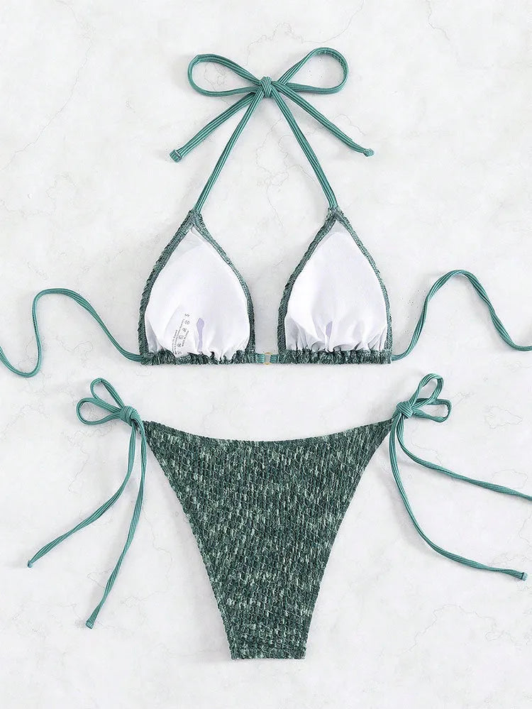 Women's green halter backless swimsuit with three-point design showing front and back styling