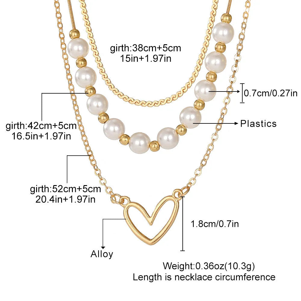 Vintage gold necklace with heart-shaped pendant on adjustable pearl-style chain