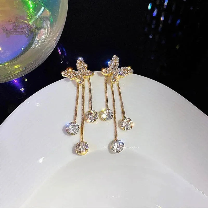 Silver butterfly rhinestone drop dangle earrings with pearl tassel chain and heart elements on alloy