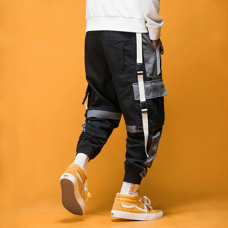 Men's loose fit hip hop beam pants in khaki cotton-rich fabric, mid waist, tether closure, small feet hem, available in black and white.