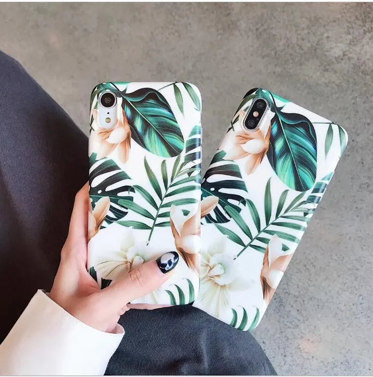 Soft TPU iPhone case with detailed floral and banana leaf art in green tones on the back.