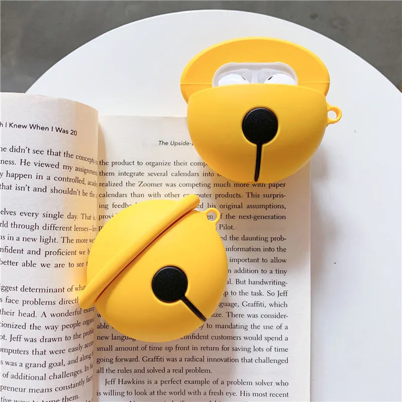 Yellow silicone AirPods case with a small silver bell charm attached