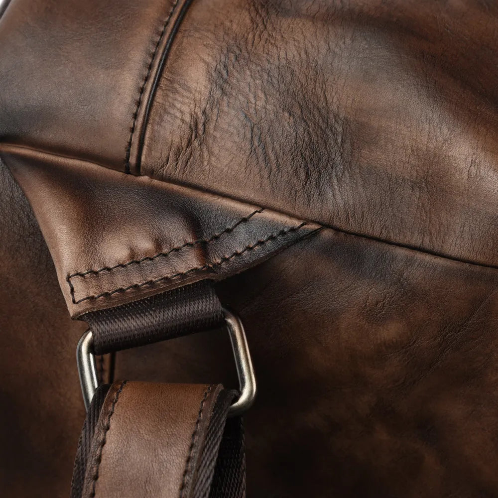 Women's retro leather bucket backpack in first layer cowhide, 25.5x30x15.5cm, with drawstring and double straps.
