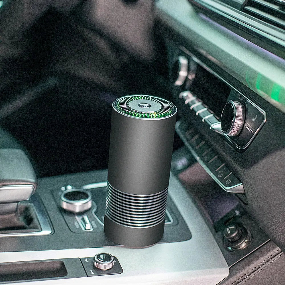 Black aluminium alloy car air purifier with USB cable on a car dashboard