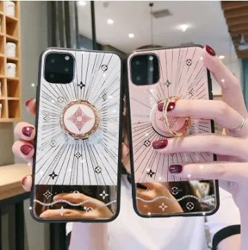Rose gold and white gold iPhone ring stands with luxury diamond design on iPhone back.