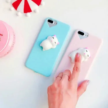 Soft pink silicone TPU phone case with a raised 3D cartoon cat design on the back, fitted to an iPhone.
