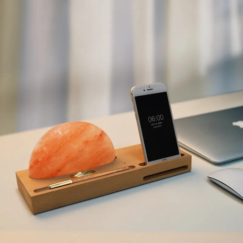 Sunrise Oriental wooden base table lamp with natural crystal salt shade and wireless phone charging pad.