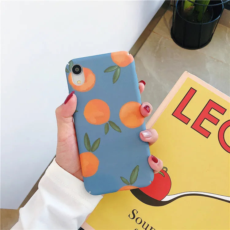 Retro orange and blue plastic back cover case for iPhone models on a table.