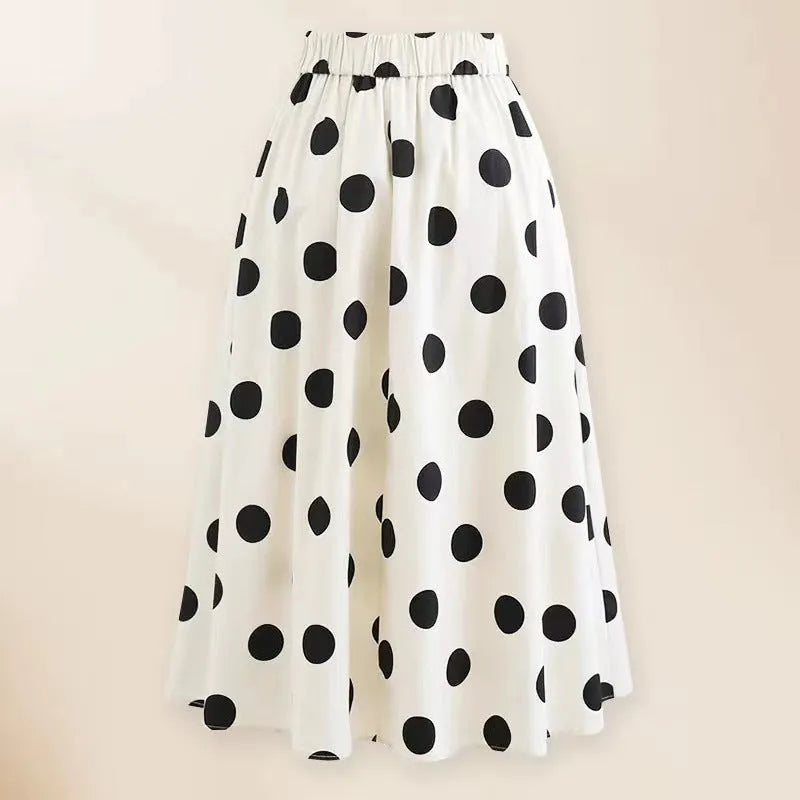 Women's black one-piece swimsuit with attached round skirt and decorative bow detail