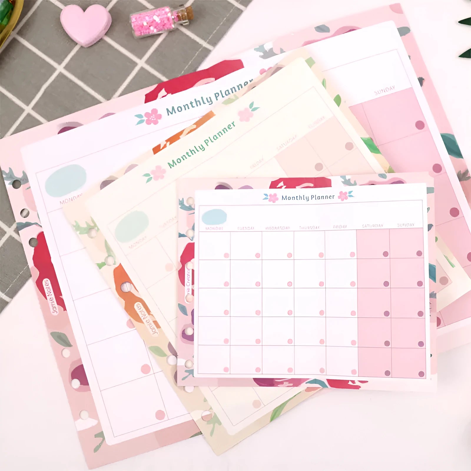 Handbook loose-leaf refill sheets showing floral monthly planner and tri-fold designs