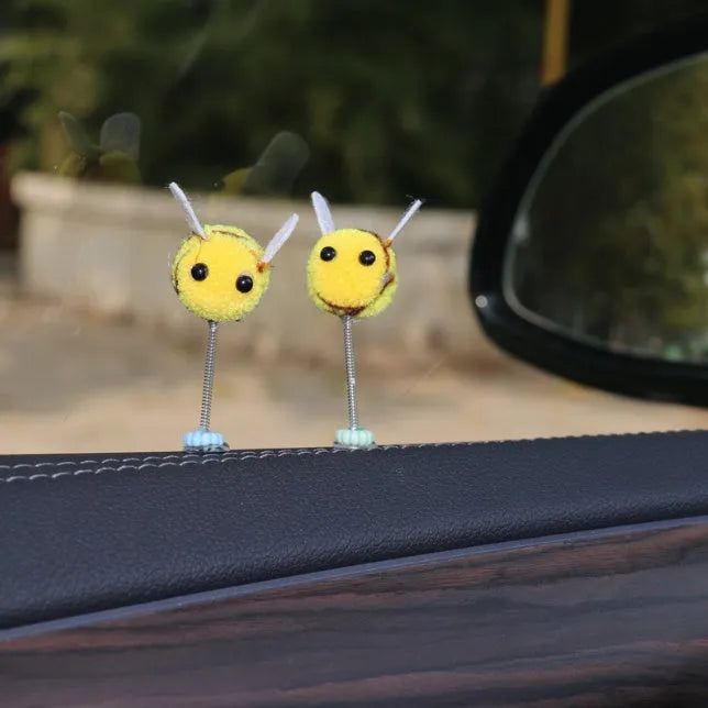 Small yellow and black fur ball bee car decoration ornament measuring 3cm.