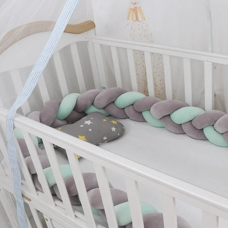 Baby crib bumper braid knot pillow cushion in spandex velvet fabric, shown in a multi-colour option.